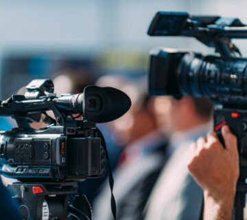 Cameraman recording event at media press conferenc 2026 01 05 06 12 00 utc 360x320